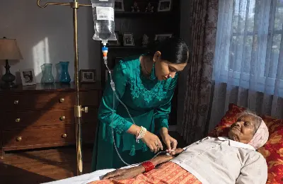Example of patient care, a registered nurse administering IV/ saline on a patient.